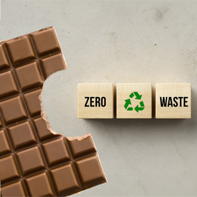Angebissene Schokolade und Würfel mit der Aufschrift "Zero Waste".